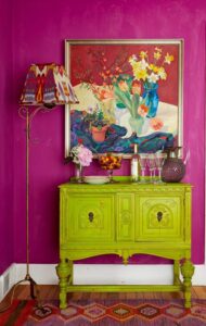 A fuchsia room with a chartreuse sideboard, showing color design at its best.