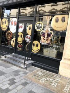 A photo of a London storefront taken by Color  Expert Leatrice Eiseman, showing smiley faces around a coronation crown.