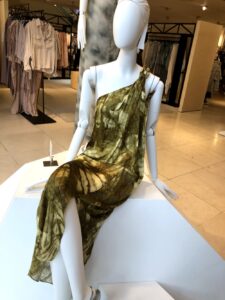 A photo of a London storefront taken by Color  Expert Leatrice Eiseman, showing a white mannequin in a gold one-shouldered dress