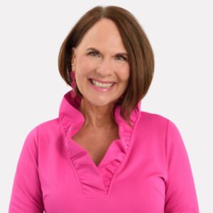 Color consultant Annette Bond wears a hot pink shirt against a white background