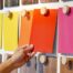 A color expert chooses a color swatch from a swatch board.