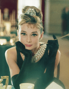 Actress Audrey Hepburn in pearls and a little black dress, as Holly Golightly in Breakfast at Tiffany's