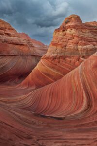 Eroded sandstone hills against a stormy sky